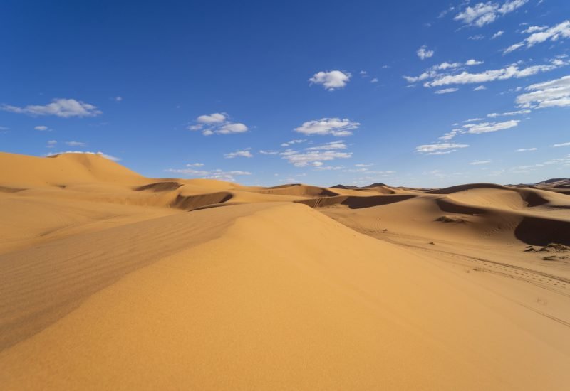Sunset light and footprints in the desert of Merzouga in Morocco